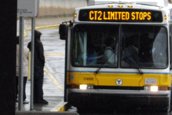 A person boarding an MBTA bus in Boston