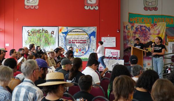 Ana Fuentes speaks on stage to a crowd of people