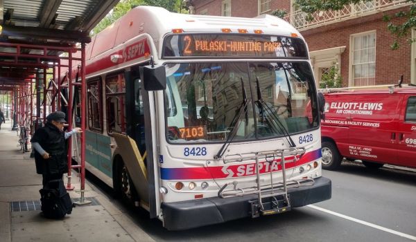 person getting on bus